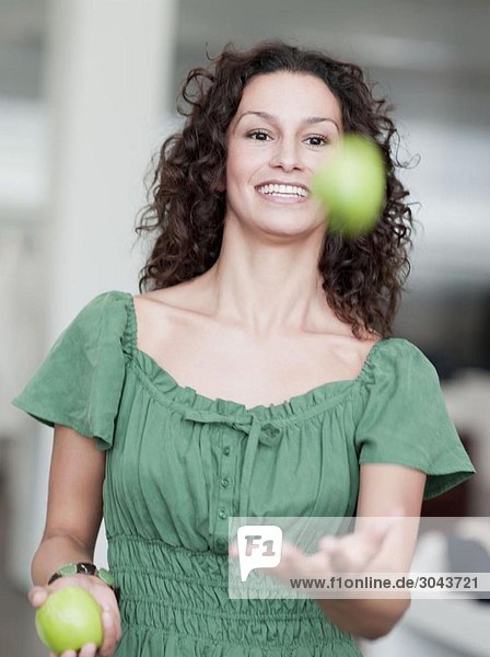 woman juggling apples
