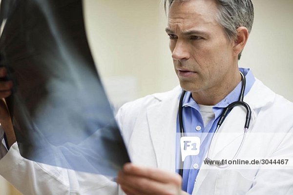 Male Doctor looking at x-ray