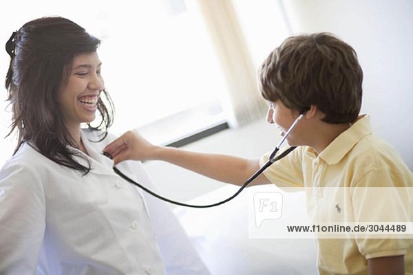 Boy listening to female Doctors heart