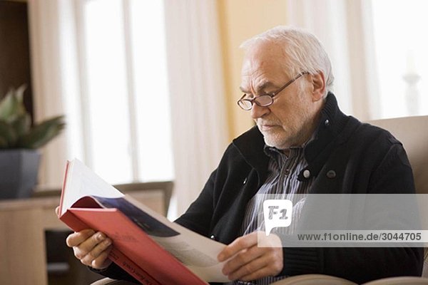 old man reading book
