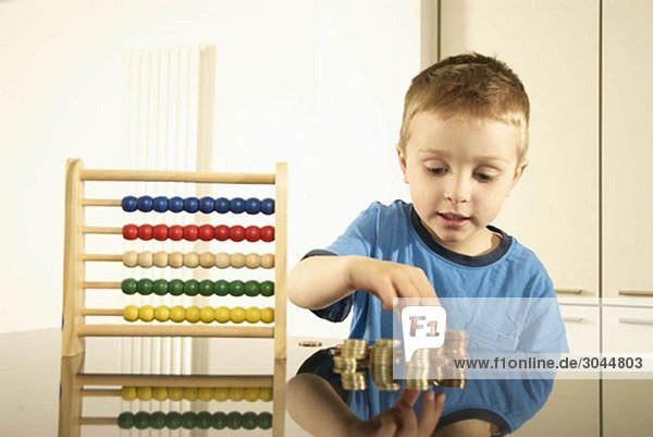 boy with money and abacus