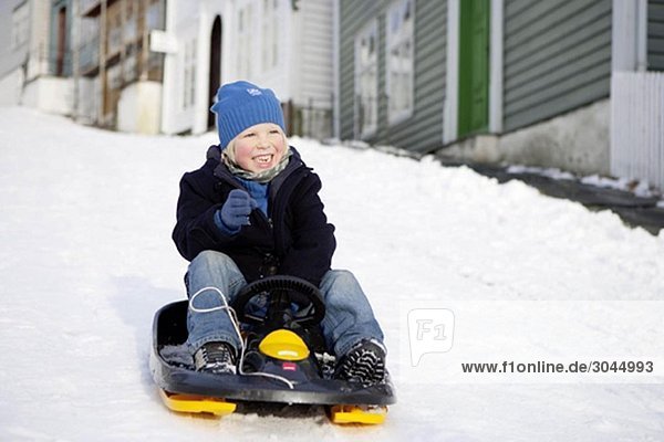 Scandinavian boy on a sled