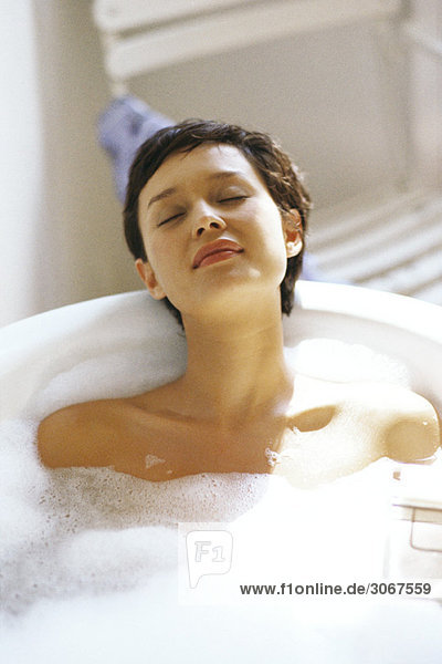 Woman taking bubble bath  relaxing