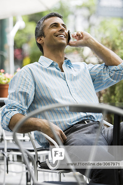 Man sitting outdoors using cell phone