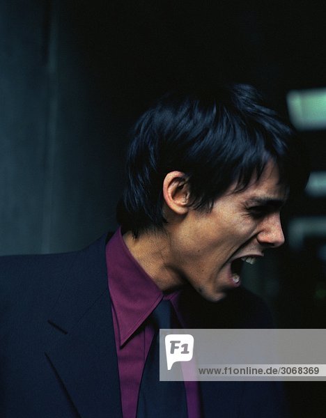Man in suit yelling side view
