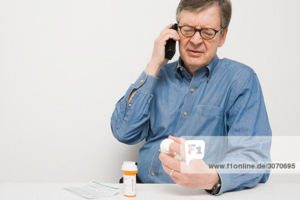 Man on telephone with medicine
