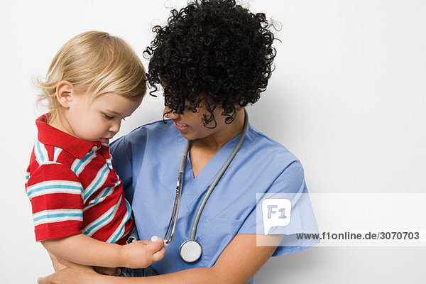 Nurse holding toddler
