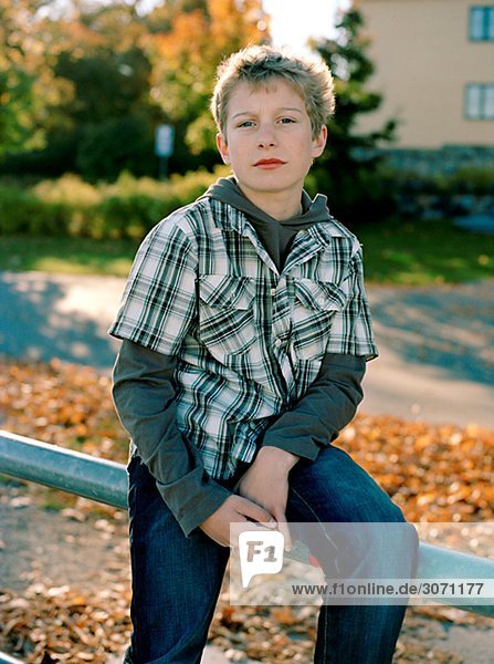 Portrait of a boy amidst autumn leaves Sweden.