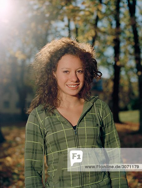 Portrait of a smiling teenage girl in the autumnal sun Sweden.