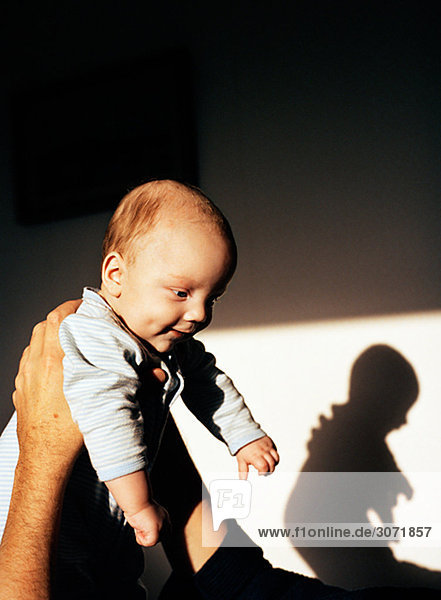 Baby with its shadow on the wall Sweden.