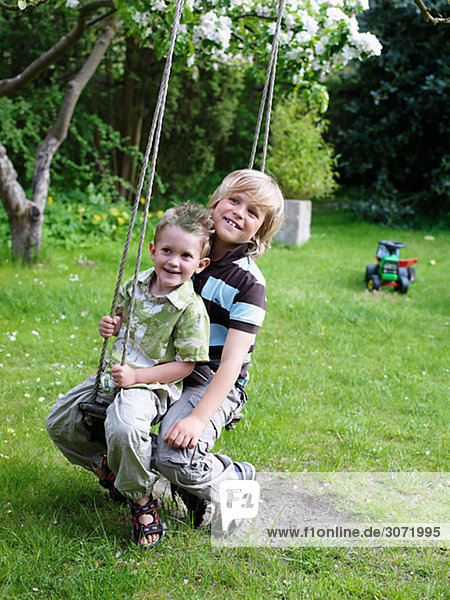 Brothers playing in a garden Skane Sweden.