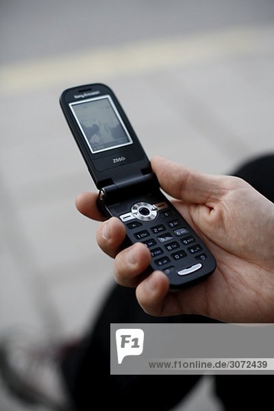 A man holding a mobile phone Sweden
