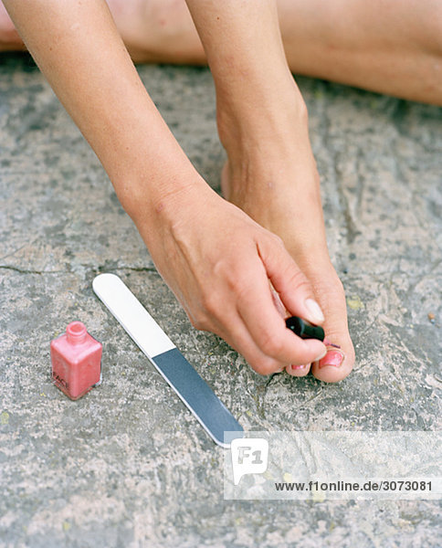 Woman using nail polish Sweden.