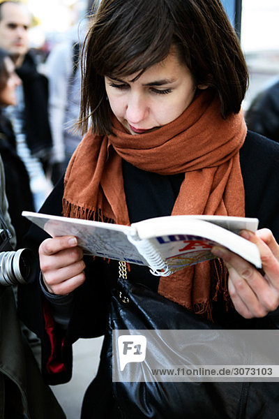 A woman reading a map London Great Britain.