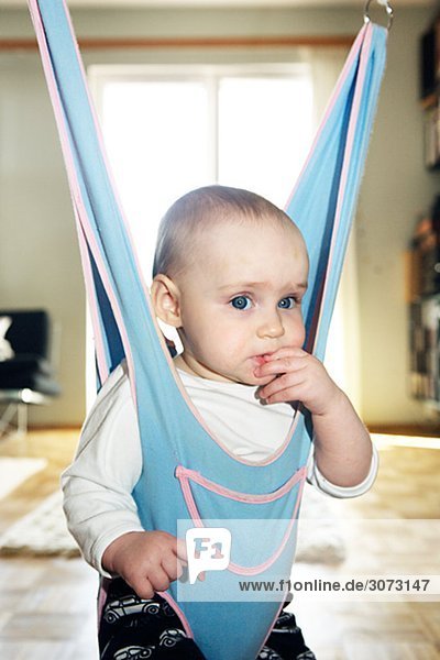 A girl in a baby bouncer Sweden.