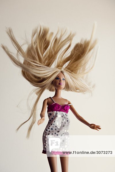 Barbie doll falling against a white background Sweden.