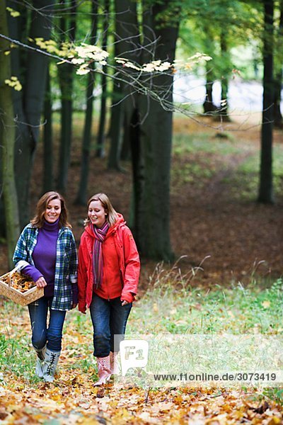 Mother and daughter walking in a forest Stockholm Sweden.