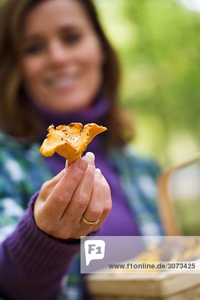 A woman holding a mushroom Sweden.