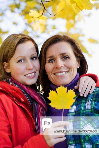 Mother and daughter holding a maple leaf Sweden.