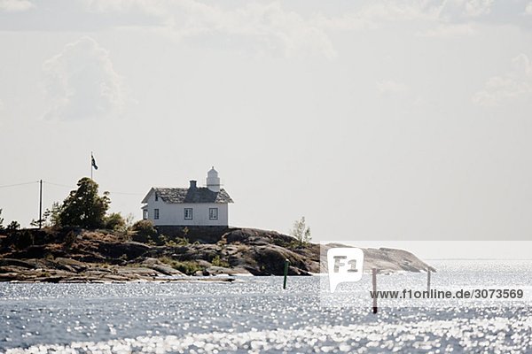 A lighthouse on a point of land lake Vaner Sweden.