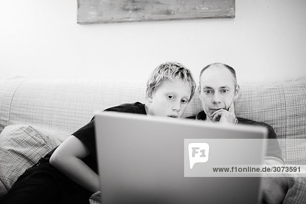 Father and son in front of a computer Sweden.