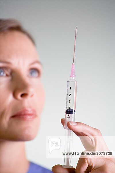 Nurse preparing injection close-up.