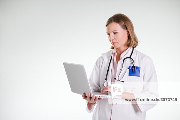 A doctor using a laptop.