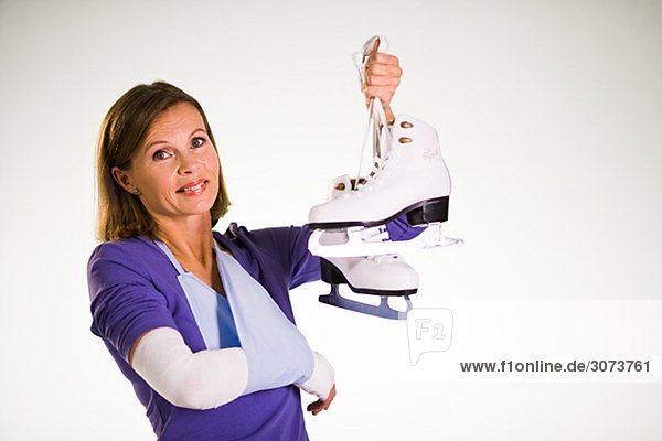 An injured woman holding skates.