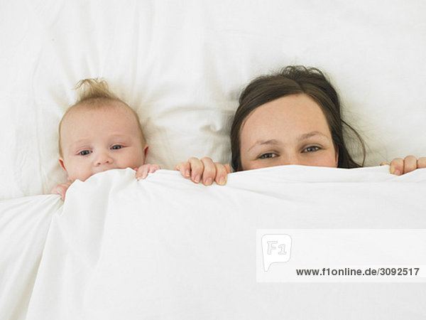 baby and mother in bed