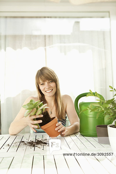 Young woman and plants on patio