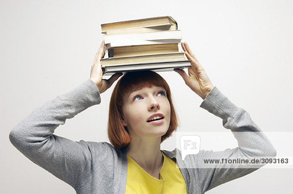 woman balancing books on head