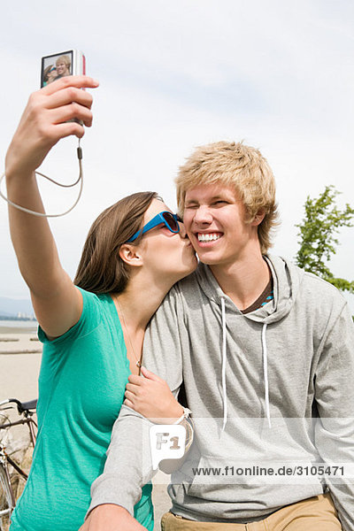 Teenage couple with digital camera