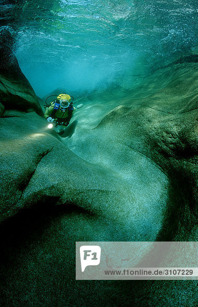 Scuba diver in the Verzasca river  Tessin  Switzerland  underwater shot