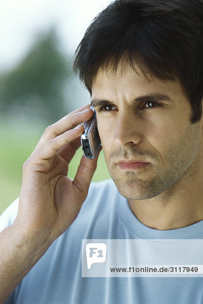 Man using cell phone with look of determination