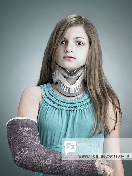 Girl with neck brace and arm in plaster