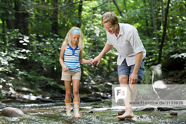 Father and daughter in river