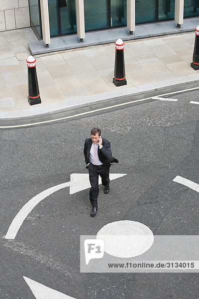 Elevated view of a businessman crossing the street