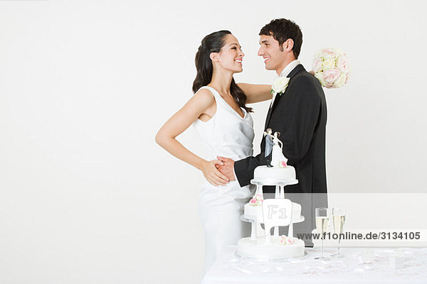 Bride and groom with a wedding cake