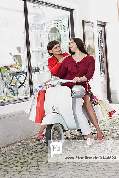 girlfriends on a motor scooter