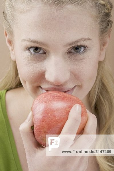 Frau isst roten Apfel