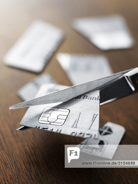 Credit card being cut up with scissors
