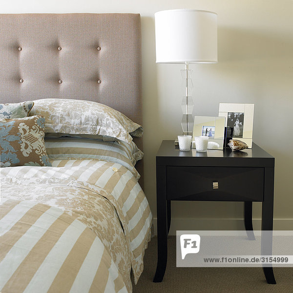 Bed with side table  candles  frames and lamp