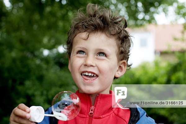 A boy blowing soap bubble