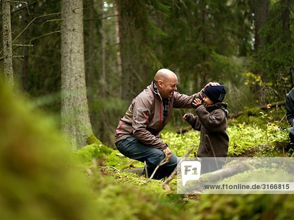 Father and son in the forest Sweden.