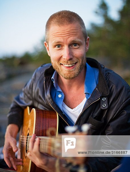 A man playing the guitar. Sweden.