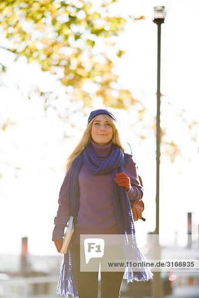 Young female student taking a walk in autumn Stockholm Sweden.