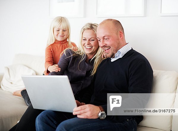 A family using a laptop Sweden.