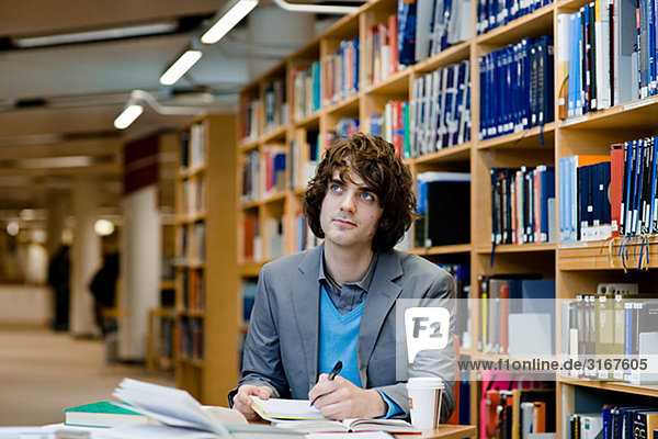 Eine männliche Studenten in einer Bibliothek Schweden.
