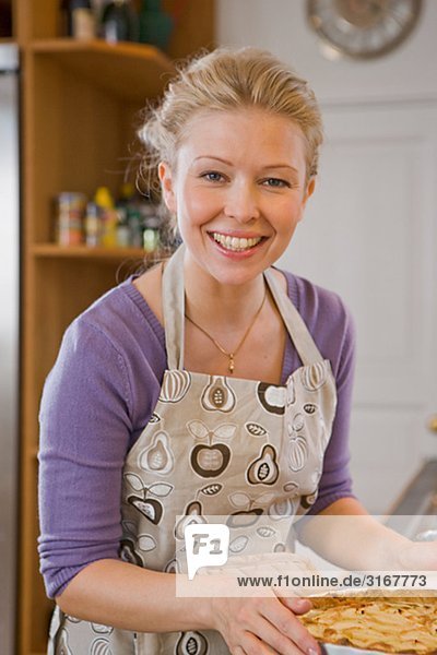 Portrait einer skandinavischen Frau hält eine frisch gebackene Torte  Schweden.