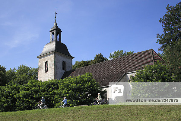 Cyclists in front of a church  Duisburg  Germany  low angle view